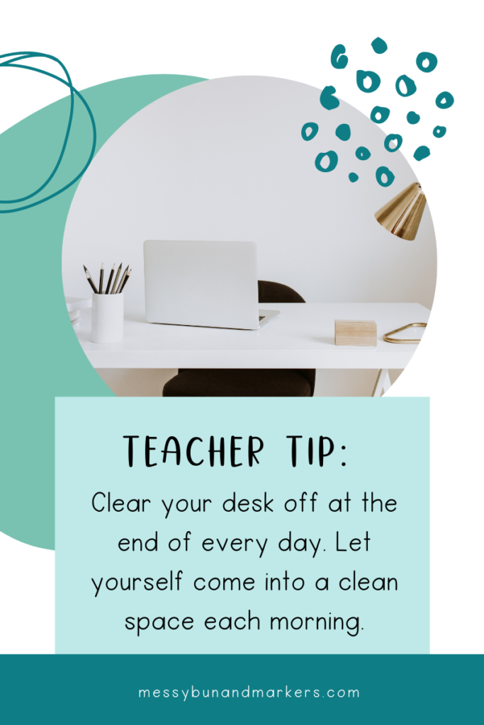 A clean teacher desk with a laptop and jar of pens.  Teacher tip: clear your desk off at the end of every day.  Let yourself come into a clean space each morning.
