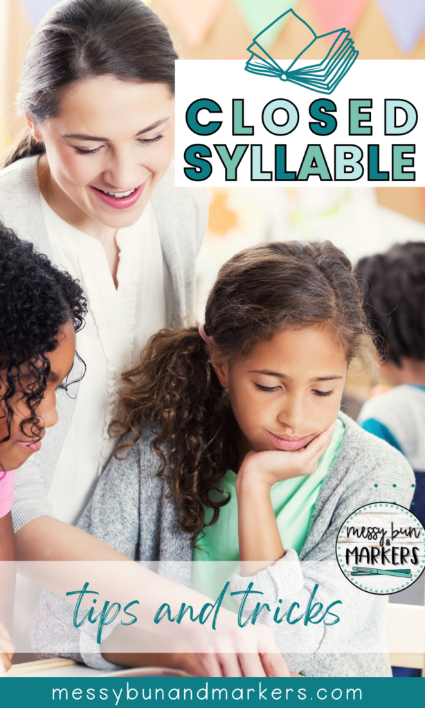 A teacher and students working on reading together. The teacher is leaning over the student to point to a word in a book.